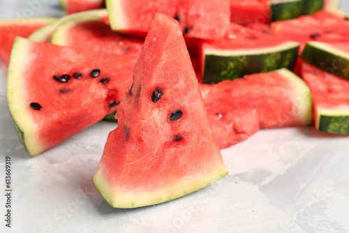 Pieces of fresh watermelon on grey background