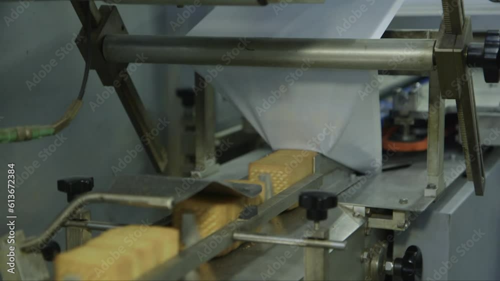 static close up shot of square cookies being packed on a conveyor line static close up shot of square cookies being packed on a conveyor line