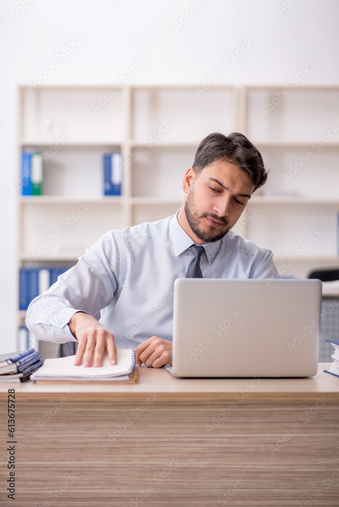Young male employee working in the office