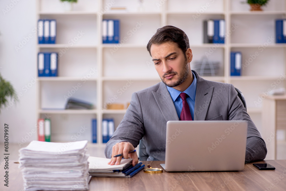 Young male employee working in the office Young male employee working in the office
