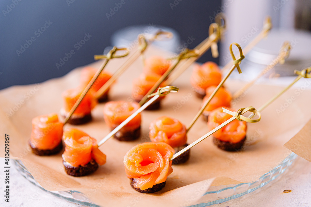 Canape with smoked salmon on wooden skewers, selective focus. Canape with smoked salmon on wooden skewers, selective focus.
