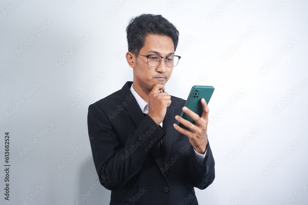 Portrait of handsome young adult with dreamy look, thinking while holding smartphone, isolated over white background. Portrait of handsome young adult with dreamy look, thinking while holding smartphone, isolated over white background.