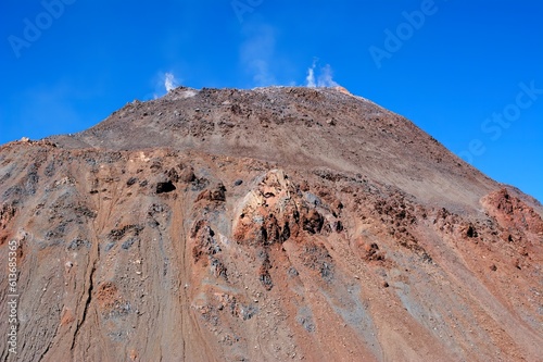 Photo of a majestic volcano in Chaiten, Chile, towering above the stunning landscape of Patagonia under a clear blue sky