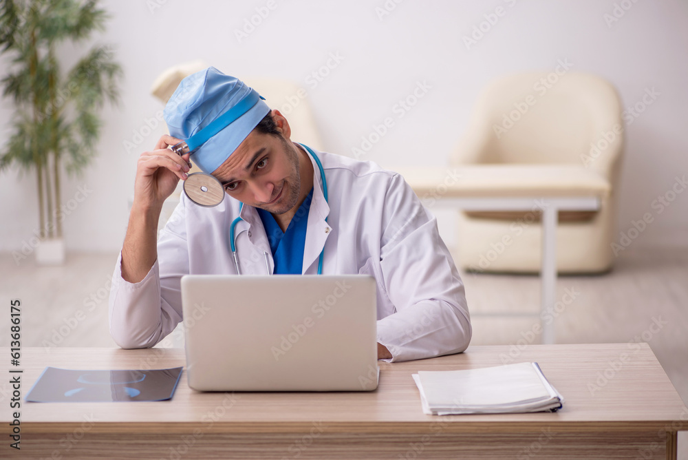 Young male doctor otologist working in the clinic Young male doctor otologist working in the clinic