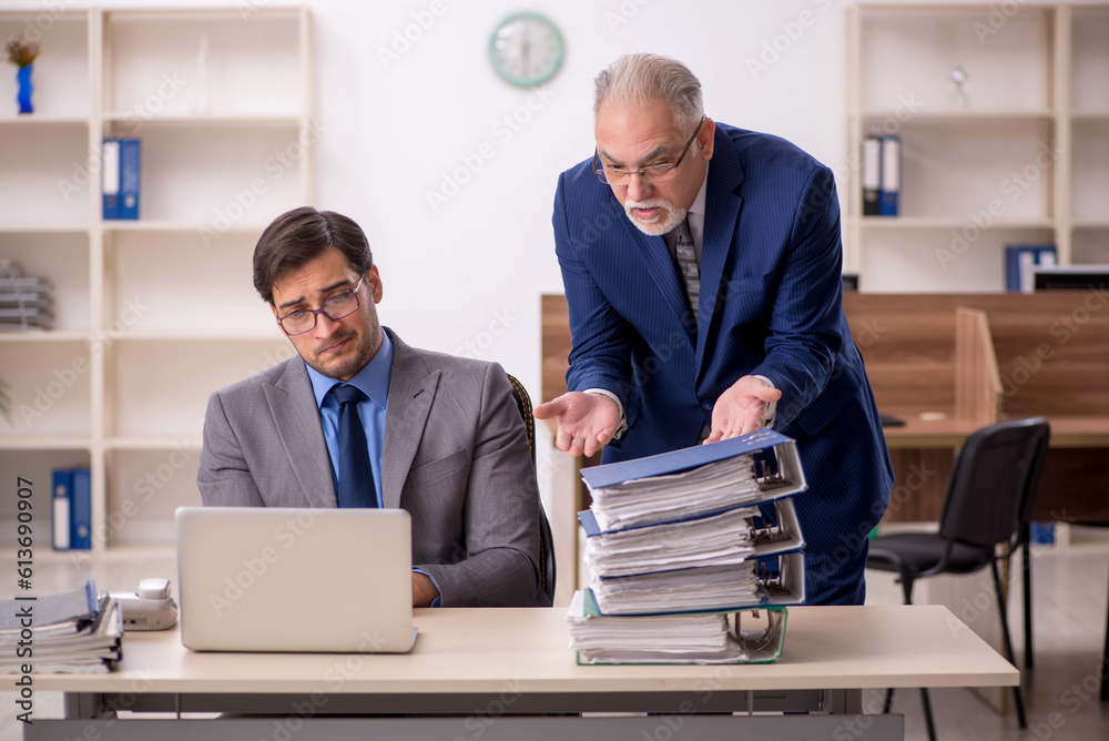 Two male colleagues working in the office Two male colleagues working in the office