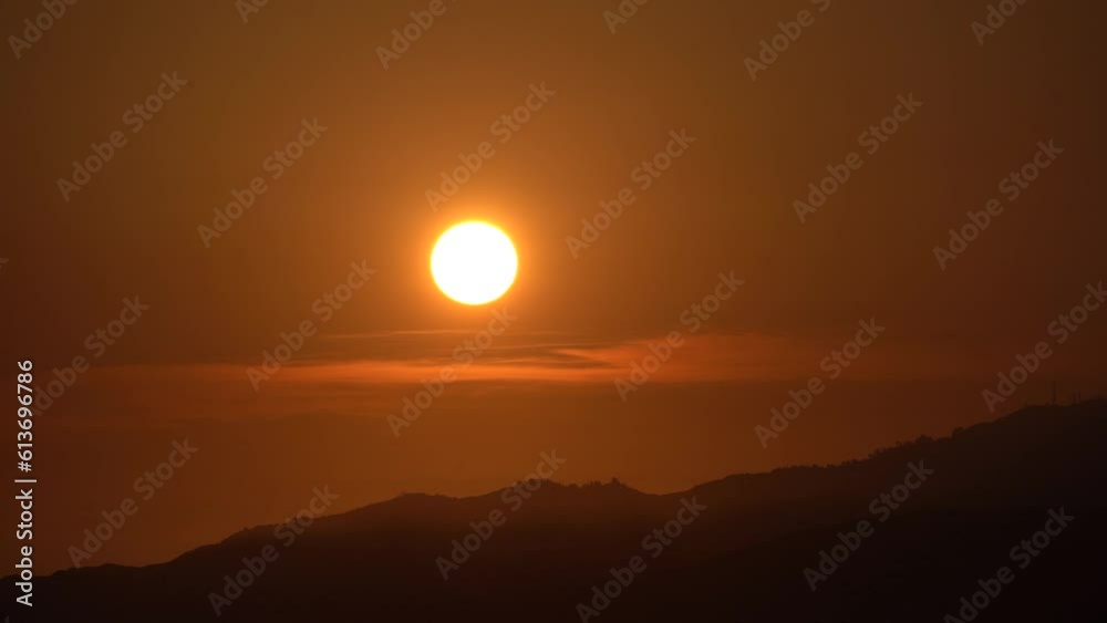 Sun Setting over tall mountaintops Sun Setting over tall mountaintops