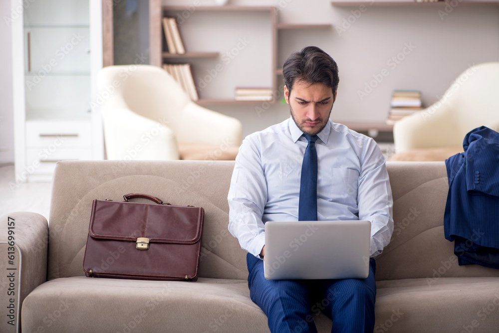 Young male employee working from home during pandemic