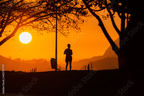 silhouettes of people running during dawn in Rio de Janeiro.