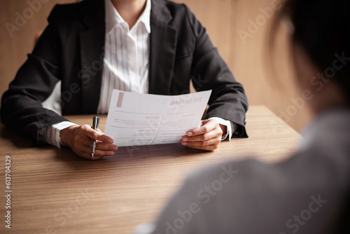 Image of employer or recruiter holding reading a resume during about colloquy his profile of candidate. photo