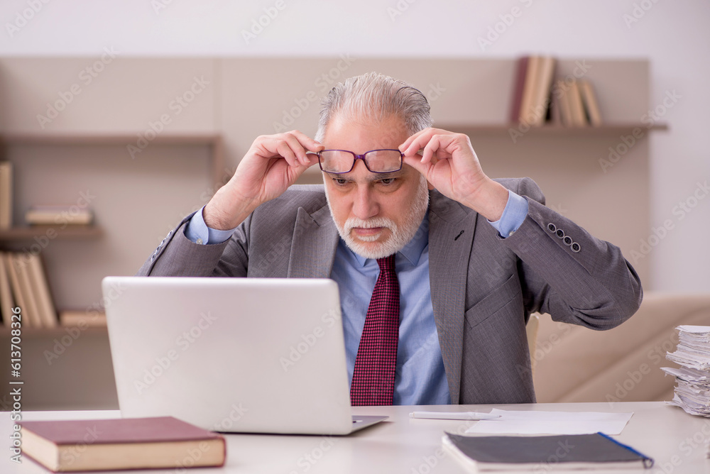 Old male employee working from home during pandemic Old male employee working from home during pandemic
