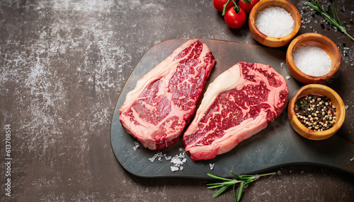 Obraz na plátně Raw grass fed ribeye steak with salt and pepper.