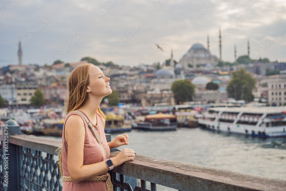 Young tourist woman on Galata bridge, Golden Horn bay, Istanbul. Panorama cityscape of famous tourist destination Bosphorus strait channel. Travel landscape Bosporus, Turkey, Europe and Asia