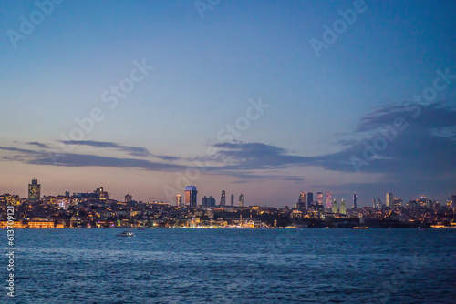 Istanbul at sunset, Turkey. Tourist boat sails on Golden Horn in summer. Beautiful sunny view of Istanbul waterfront with old mosque. Concept of travel, tourism and vacation in Istanbul and Turkey © galitskaya
