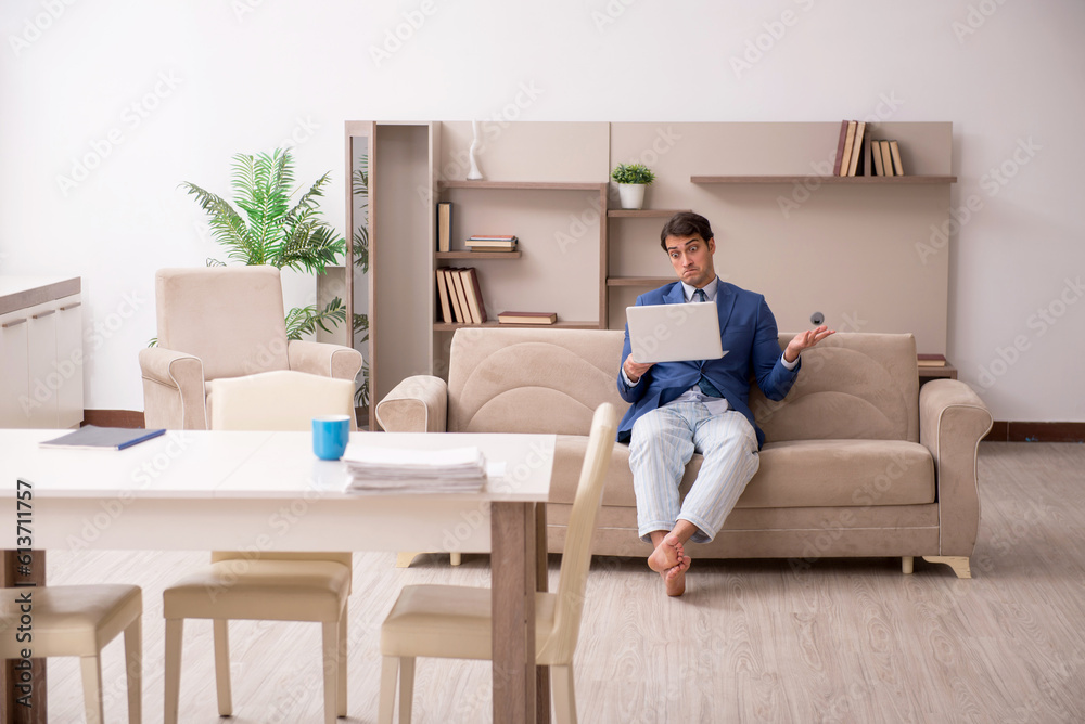 Young male employee working from home during pandemic Young male employee working from home during pandemic