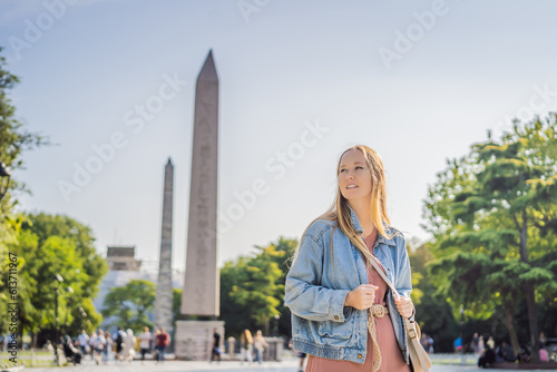 Woman Tourist in Istanbul against the background of Obelisk of Theodosius is the Ancient Egyptian obelisk of Pharaoh Thutmose III places in the Hippodrome of Constantinople, Turkey. Theodosius photo