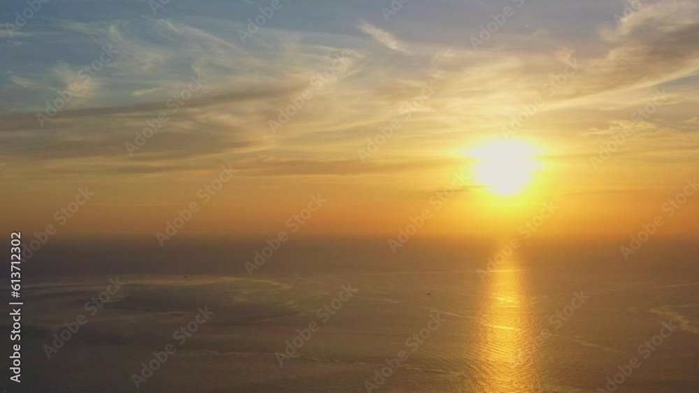aerial view scenery reflection of yellow sunset at Promthep ocean..Clouds moving in nature in a cloudscape sky..Scene of Colorful romantic sky sunset with gold color of the sky background. aerial view scenery reflection of yellow sunset at Promthep ocean..Clouds moving in nature in a cloudscape sky..Scene of Colorful romantic sky sunset with gold color of the sky background.