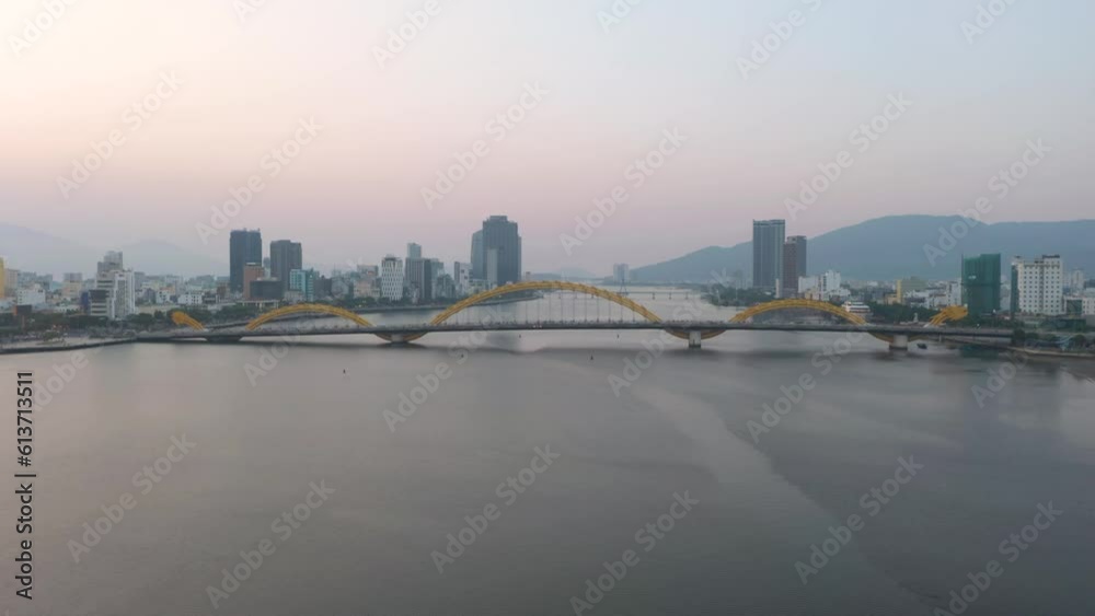 Colorful wide aerial of iconic Dragon Bridge Cau Rong, traffic and city skyline during sunset in Danang, Vietnam. Colorful wide aerial of iconic Dragon Bridge Cau Rong, traffic and city skyline during sunset in Danang, Vietnam.