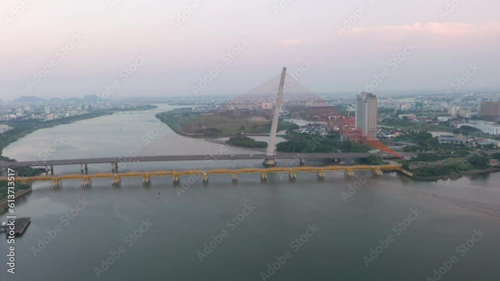 Colorful wide aerial of Tran Thi Ly Bridge, traffic and city skyline during sunset in Danang, Vietnam. Colorful wide aerial of Tran Thi Ly Bridge, traffic and city skyline during sunset in Danang, Vietnam.