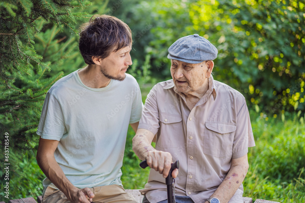 Grandfather and adult grandson spend time together in the park Grandfather and adult grandson spend time together in the park