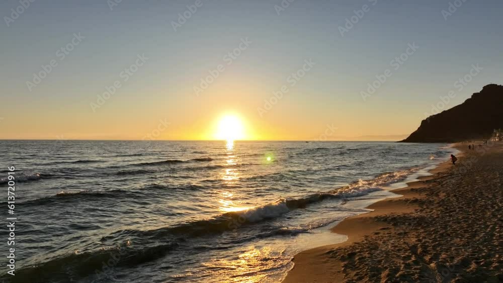 Drone video reveals a trajectory towards the sun as a small boat passes through the sea. Drone video reveals a trajectory towards the sun as a small boat passes through the sea.
