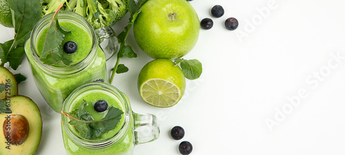 Healthy green smoothie in a jar mug on white background