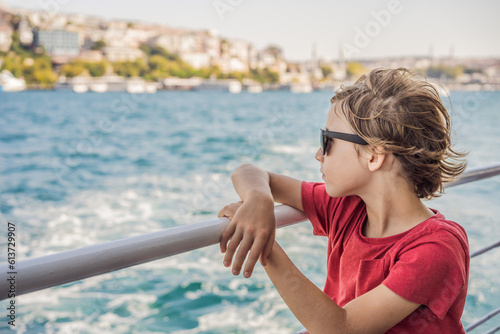 Happy boy enjoying the sea from ferry boat crossing Bosphorus in Istanbul. Summer trip to Istanbul. Traveling with kids concept © galitskaya