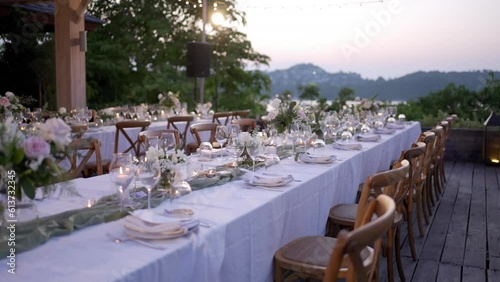 Close up long table set up reception wedding. dinner outdoor hotel resort  during sunset.