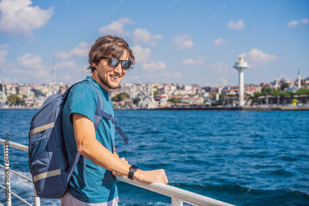 Happy man enjoying the sea from ferry boat crossing Bosphorus in Istanbul. Summer trip to Istanbul