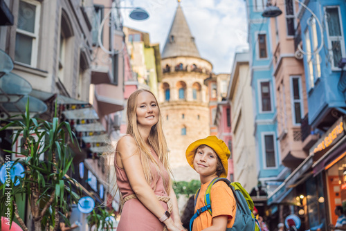 Portrait of beautiful mother and son tourists with view of Galata tower in Beyoglu, Istanbul, Turkey. Turkiye. Traveling with kids concept © galitskaya