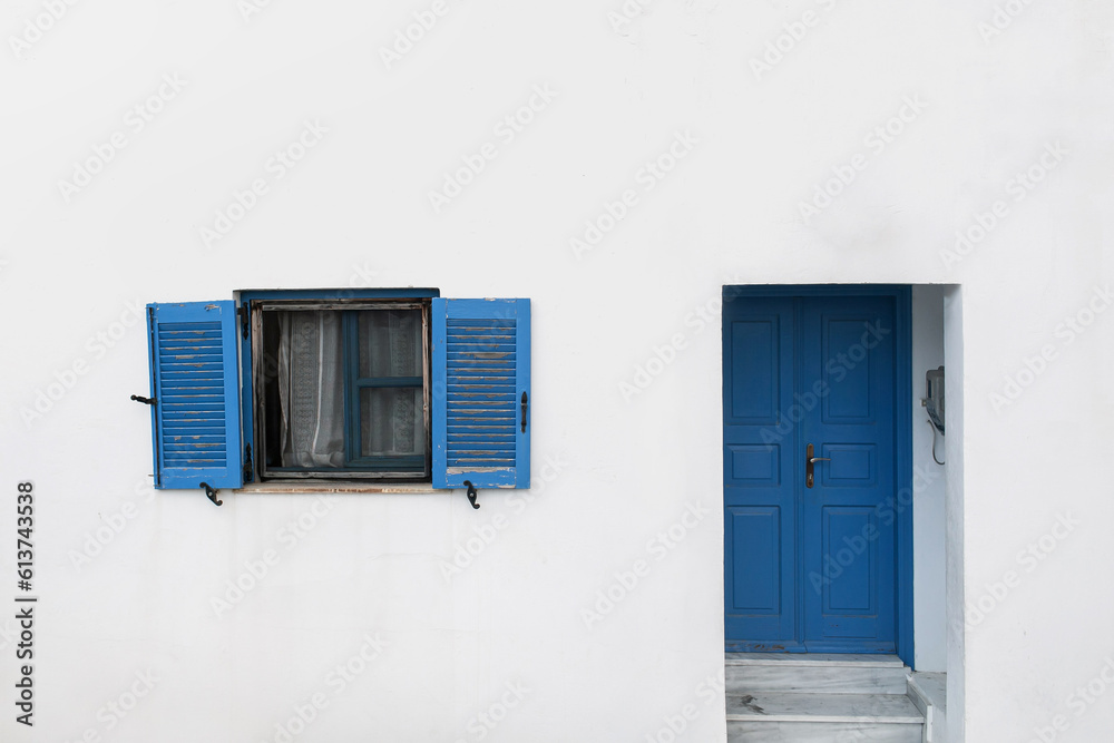 Old ancient colorful textured door and window in a stone wall in Greece, Oia, Santorini. Vintage doorway. Traditional European, Greek architecture. Summer travel