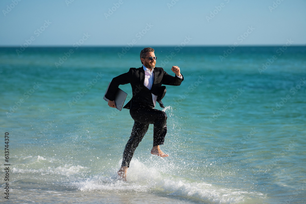 Excited businessman in wet suit run in sea. Funny business man, crazy comic business concept. Remote online working. Crazy summer business. Fun business lifestyle. Funny freelance businessman. Excited businessman in wet suit run in sea. Funny business man, crazy comic business concept. Remote online working. Crazy summer business. Fun business lifestyle. Funny freelance businessman.