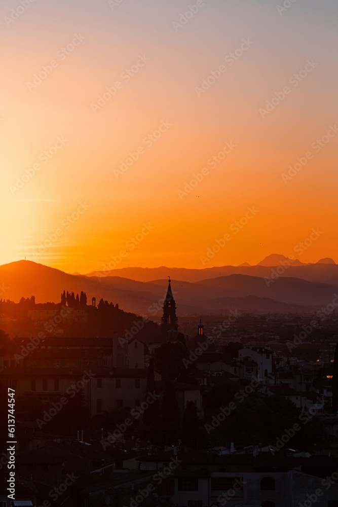 Skyline view at a city in tuscany at sunset
