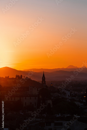 Skyline view at a city in tuscany at sunset