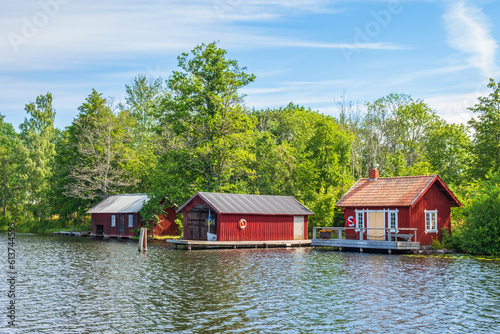 Print op canvas Beach with a red cabin and boathouse on the Göta Canal in Sweden