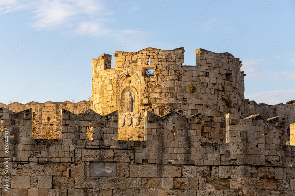 Medieval stone tower in the harbour of Rhodes, Greece illuminated by the morning sun