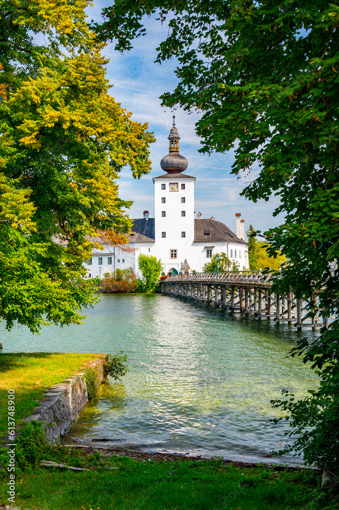 Schloss Ort castle near Traunsee, Austria. View of ancient castle with long bridge over lake. Famous tourist destination.