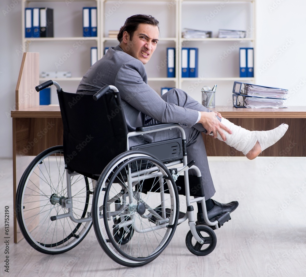 Male employee in wheel-chair in the office