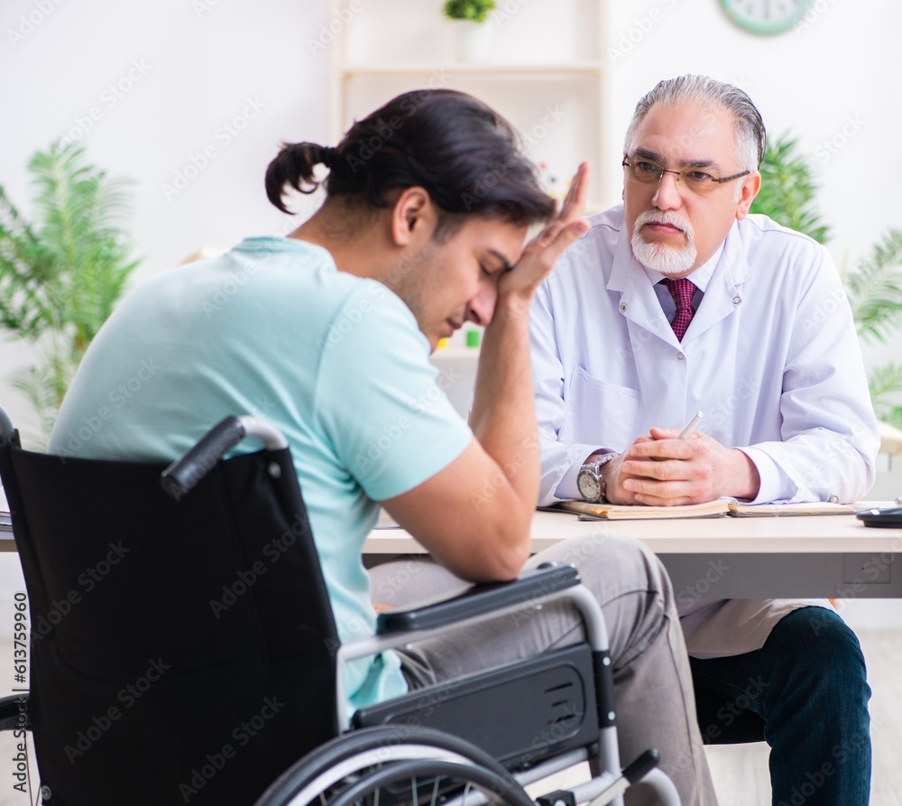 Fototapeta premium Male patient in wheel-chair visiting old doctor