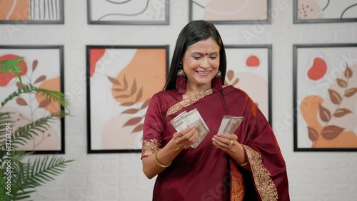 Indian mother counting money with happiness