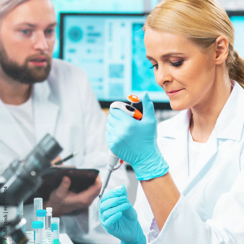 Medical scientists working in lab. Doctor teaching interns to make analyzing research. Laboratory tools: microscope, test tubes, equipment. Science and health care concept. Medical scientists working in lab. Doctor teaching interns to make analyzing research. Laboratory tools: microscope, test tubes, equipment. Science and health care concept.