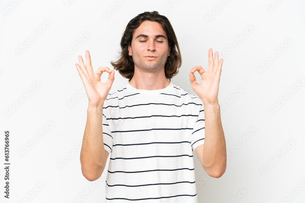 Young handsome man isolated on white background in zen pose Young handsome man isolated on white background in zen pose
