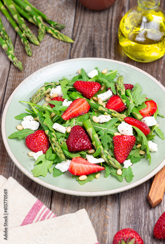 Salad with strawberries, asparagus, arugula, white cheese and nuts. Healthy eating. Vegetarian food.