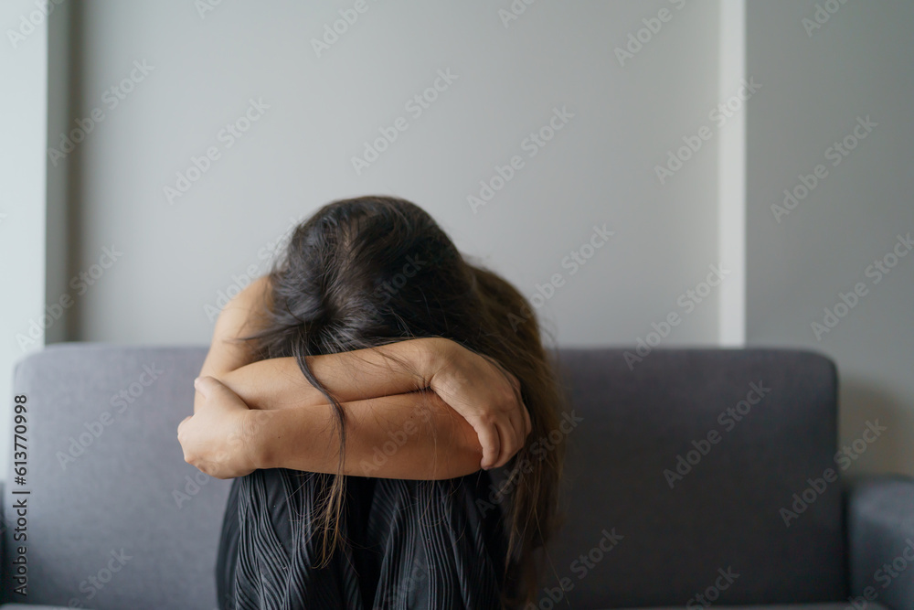 Sad woman thinking about problems sitting on a sofa upset girl feeling lonely and sad from bad relationship or Depressed woman disorder mental health. Sad woman thinking about problems sitting on a sofa upset girl feeling lonely and sad from bad relationship or Depressed woman disorder mental health.