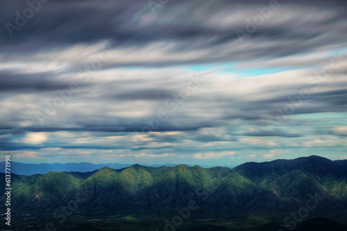 The light hits the mountains and the clouds motion. (Lampang province, Thailand). amazing natural landscape. popular attractions best famous tourist attractions © Puwaphat