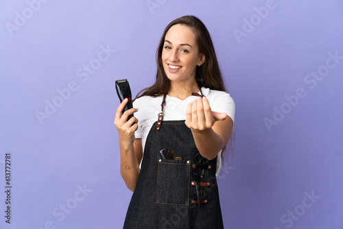 Young hairdresser woman over isolated background inviting to come with hand. Happy that you came