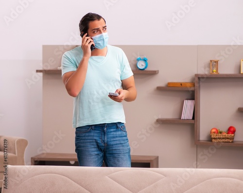 Young man boring at home during pandemic photo