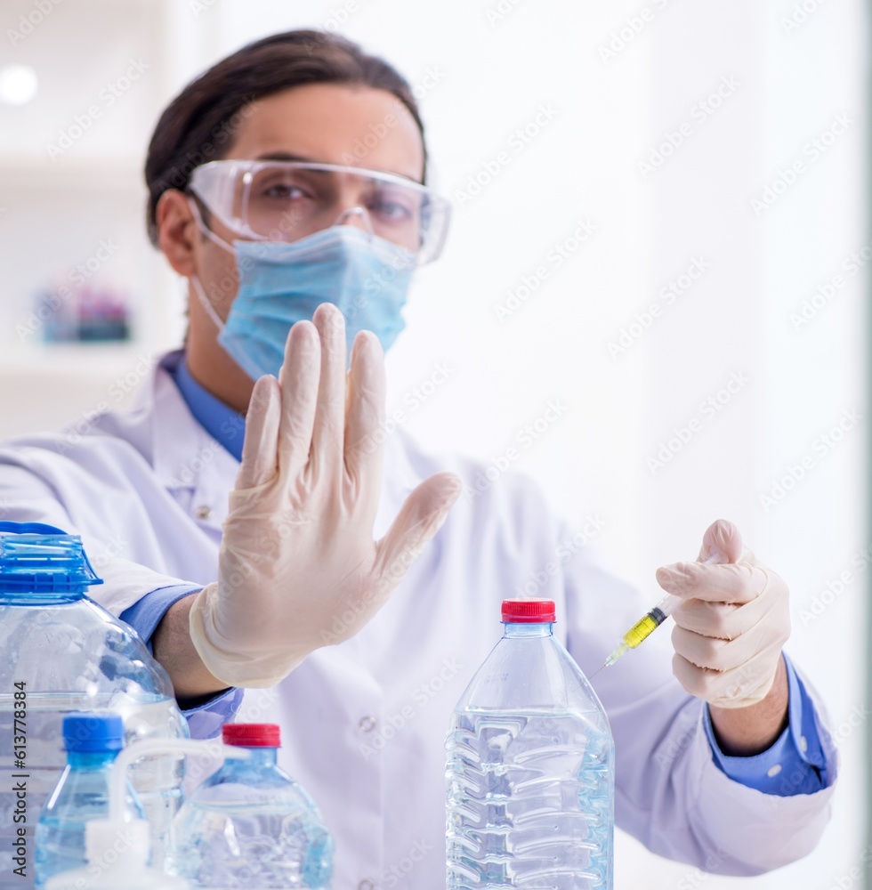 Young male chemist experimenting in lab Young male chemist experimenting in lab