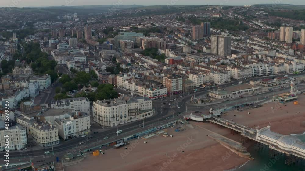 Pan down aerial shot over Brighton Marine parade road roundabout at dusk Pan down aerial shot over Brighton Marine parade road roundabout at dusk