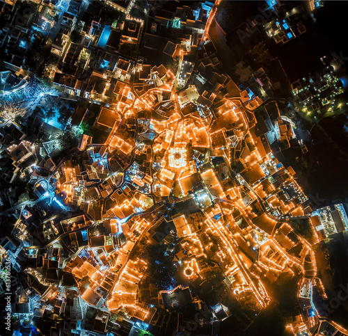 Top down aerial image of the illuminated Greek village of Pyrgos on Santorini during good friday celebrations of orthodox easter  