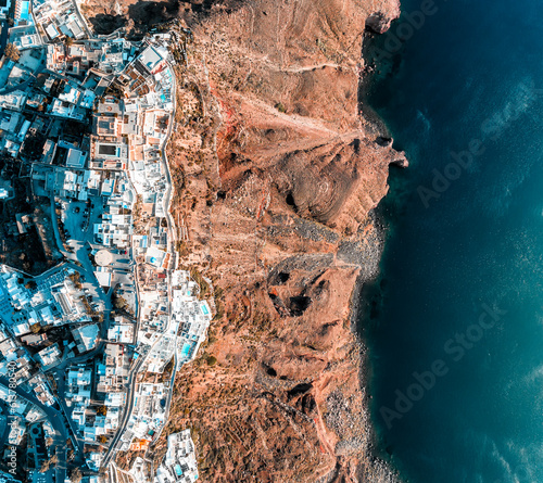 Top down aerial image of the Greek city Fira on the edge of the Caldera cliff on Santorini